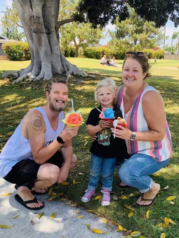 Family enjoying shave ice in the park